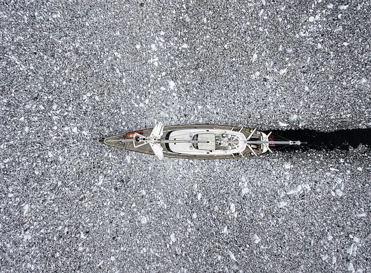 a silver and gold boat on a gravel surface aboard ROSEHEARTY Yacht for Charter