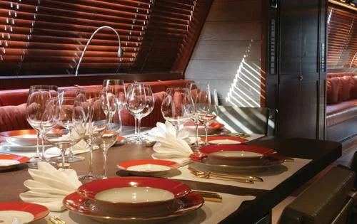 a table with plates and glasses aboard ROSEHEARTY Yacht for Charter