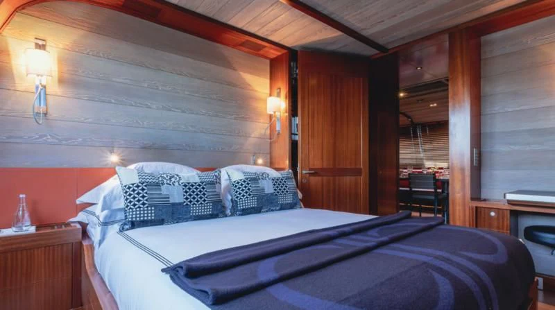 a bed with a blue sheet aboard ROSEHEARTY Yacht for Charter