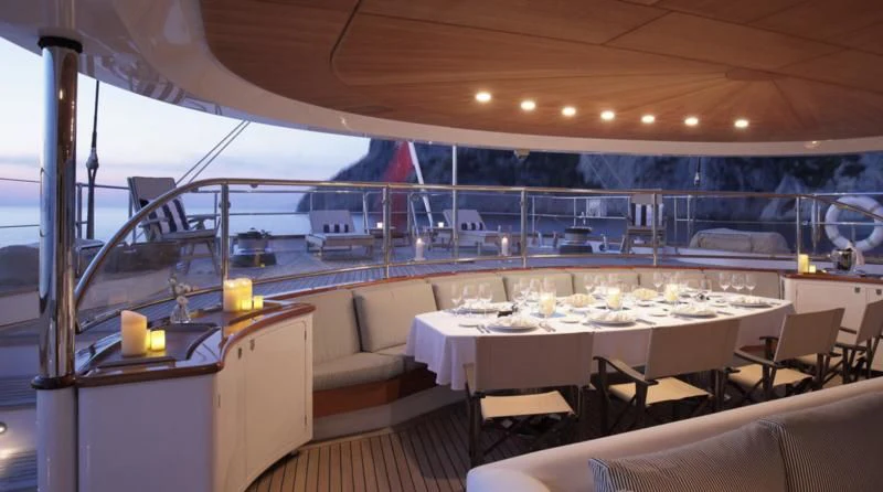 a room with tables and chairs aboard ROSEHEARTY Yacht for Charter