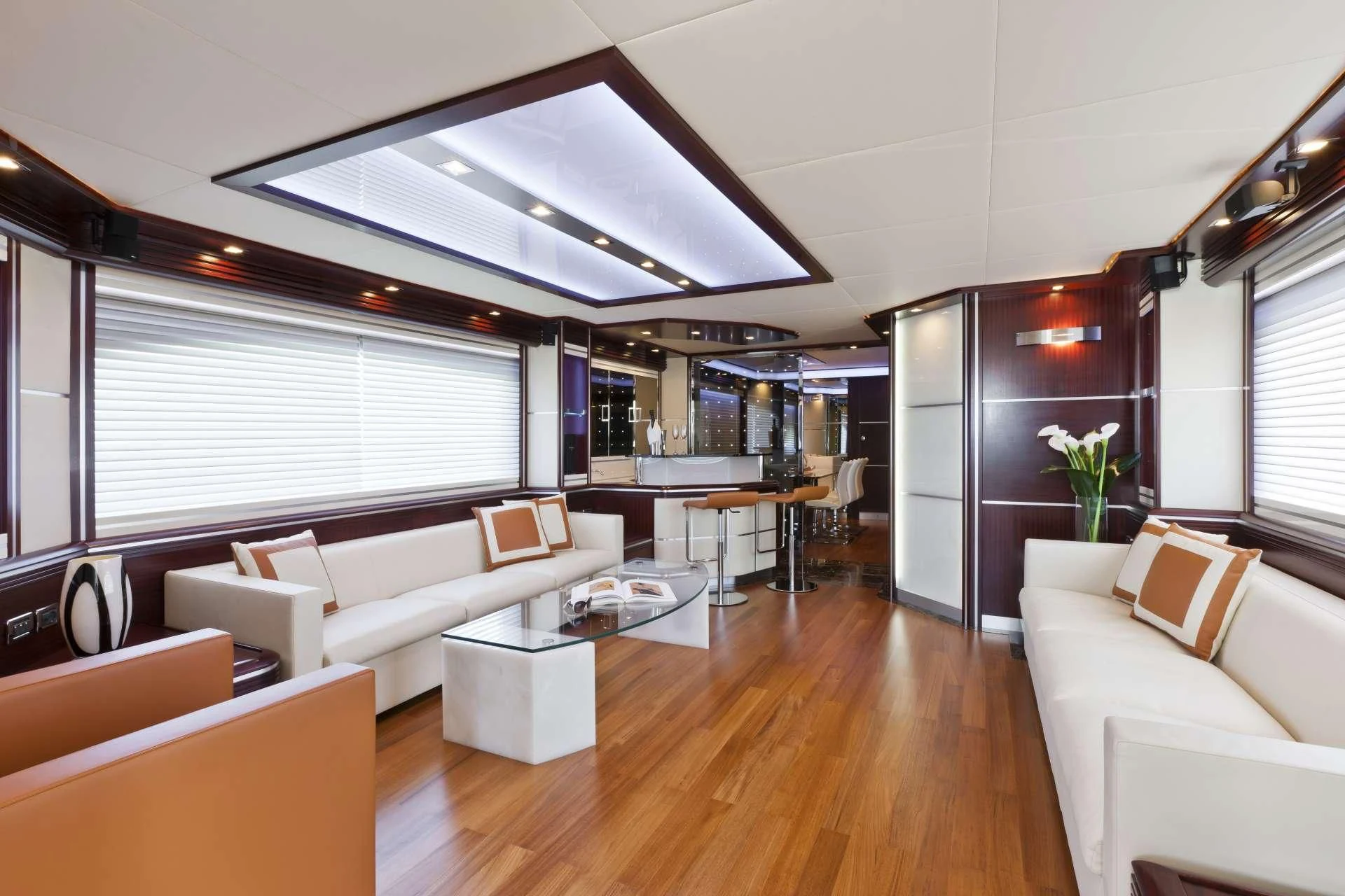 a living room with a wood floor aboard NASEEM Yacht for Sale