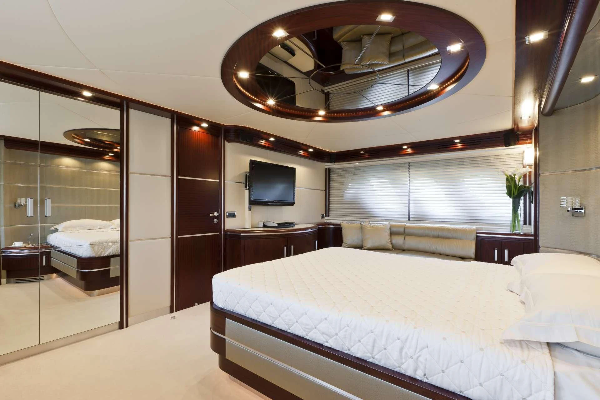 a large hotel room with a large bed and a large mirror aboard NASEEM Yacht for Sale