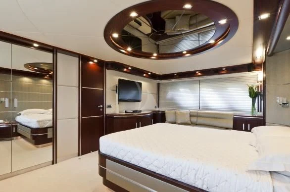a large hotel room with a large bed and a large mirror aboard NASEEM Yacht for Sale