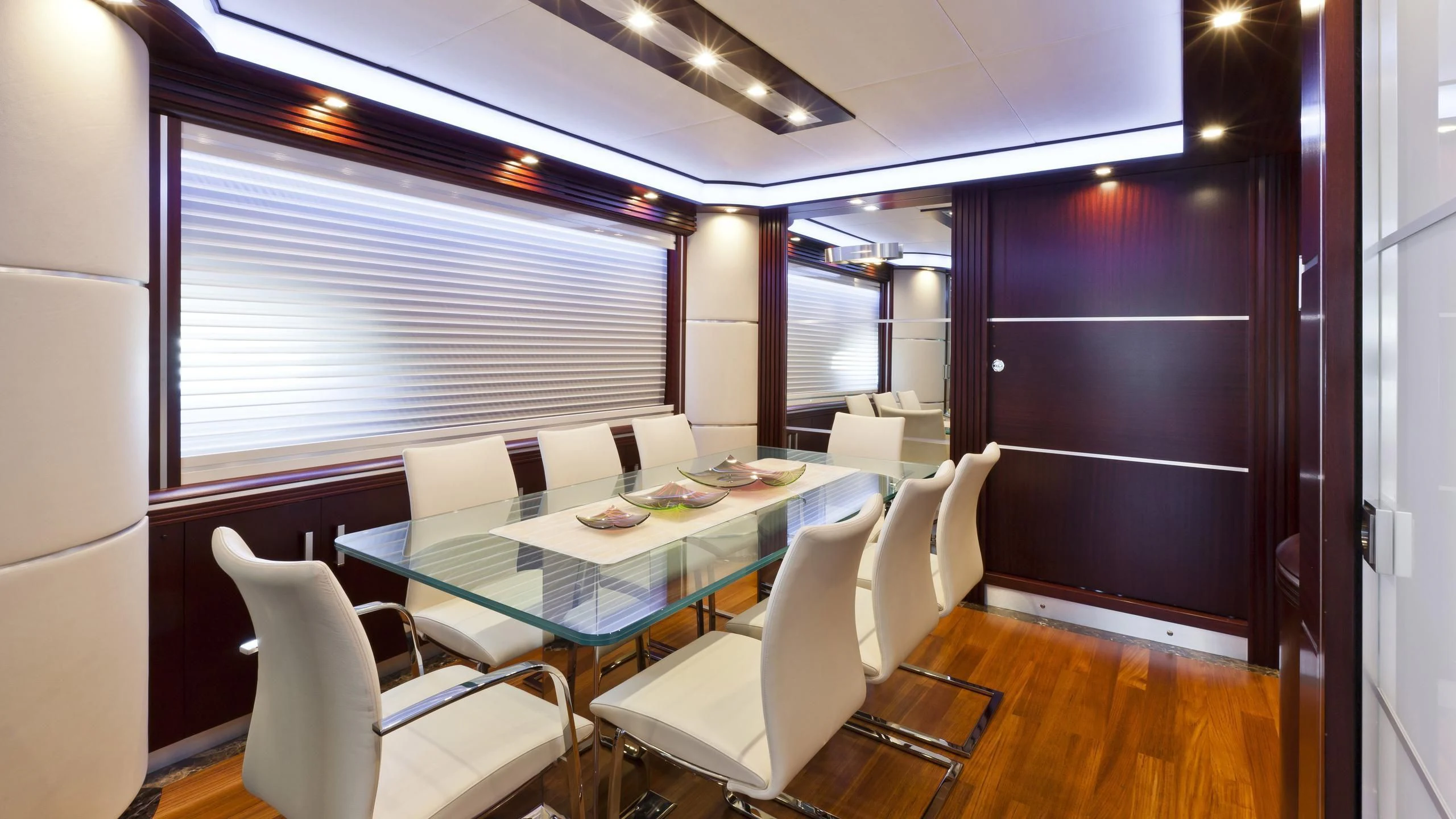 a room with a table chairs and a window aboard NASEEM Yacht for Sale