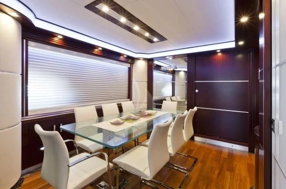 a room with a table chairs and a window aboard NASEEM Yacht for Sale