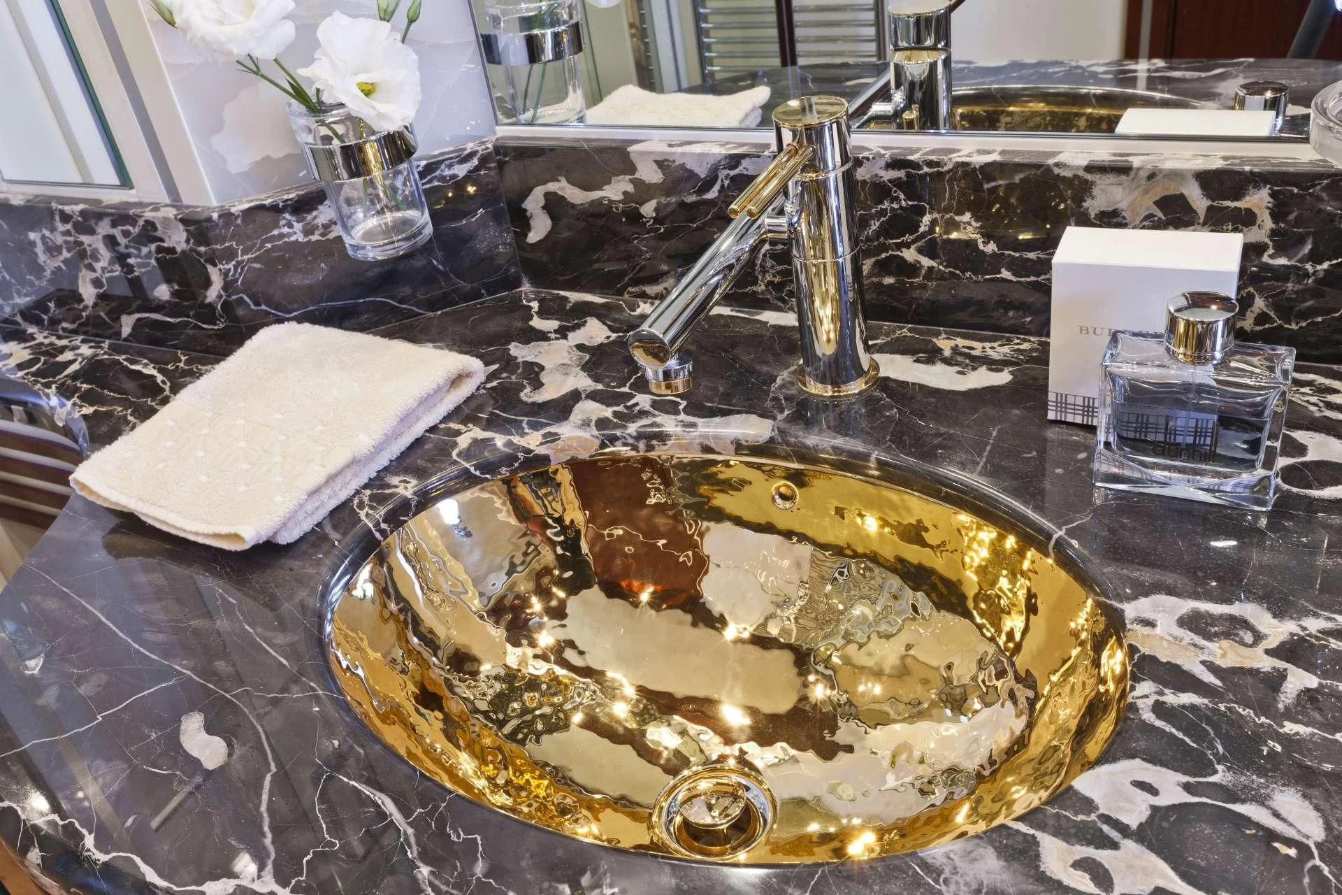 a gold plate with a spoon on it aboard NASEEM Yacht for Sale