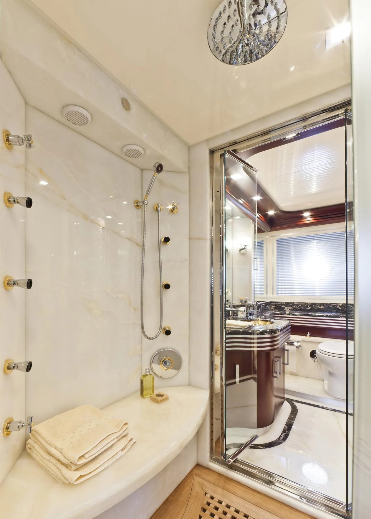 a bathroom with a large mirror aboard NASEEM Yacht for Sale