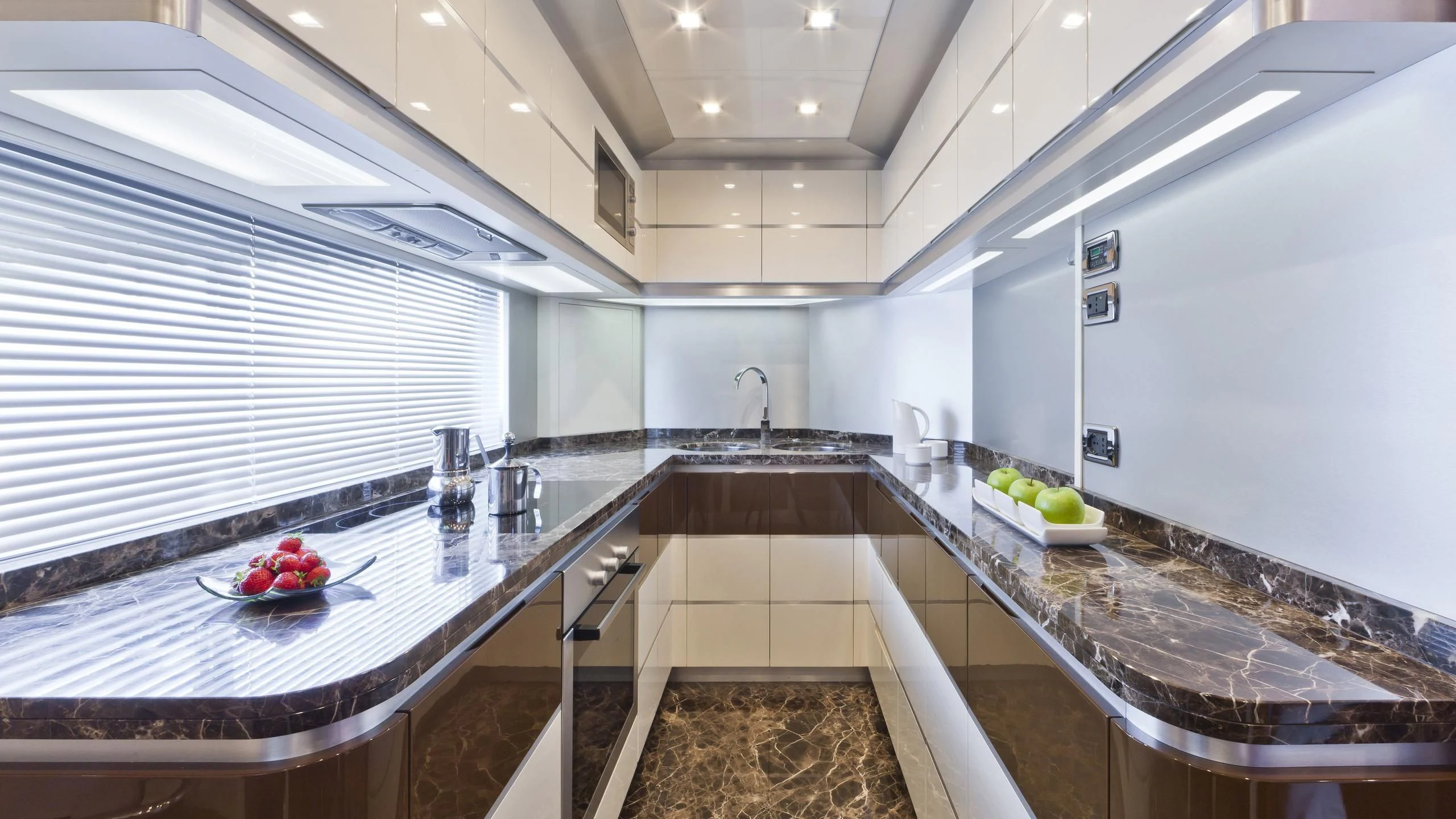a kitchen with marble counters aboard NASEEM Yacht for Sale