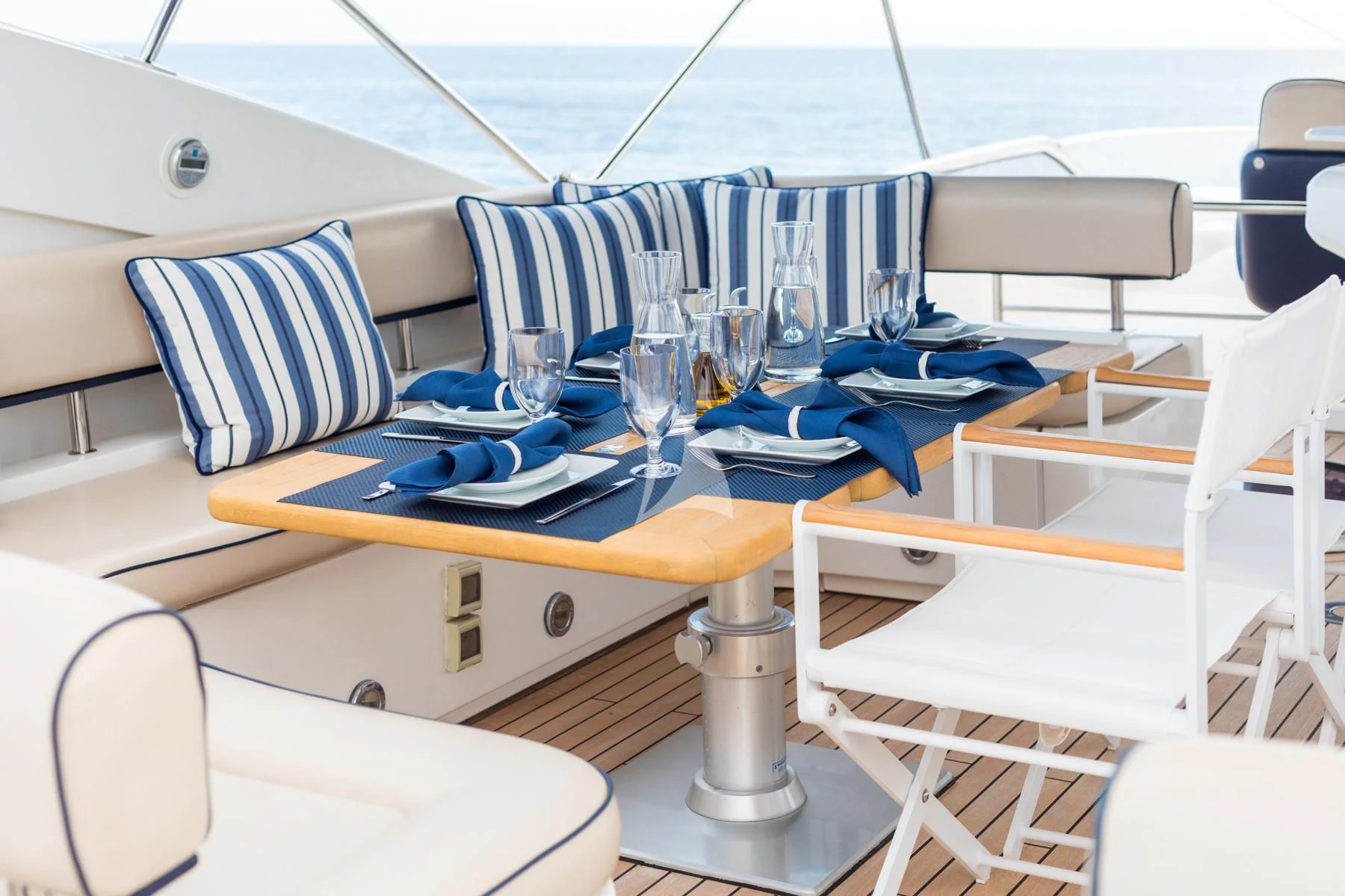 a table with chairs and a glass on it aboard WINNING STREAK 2 Yacht for Sale