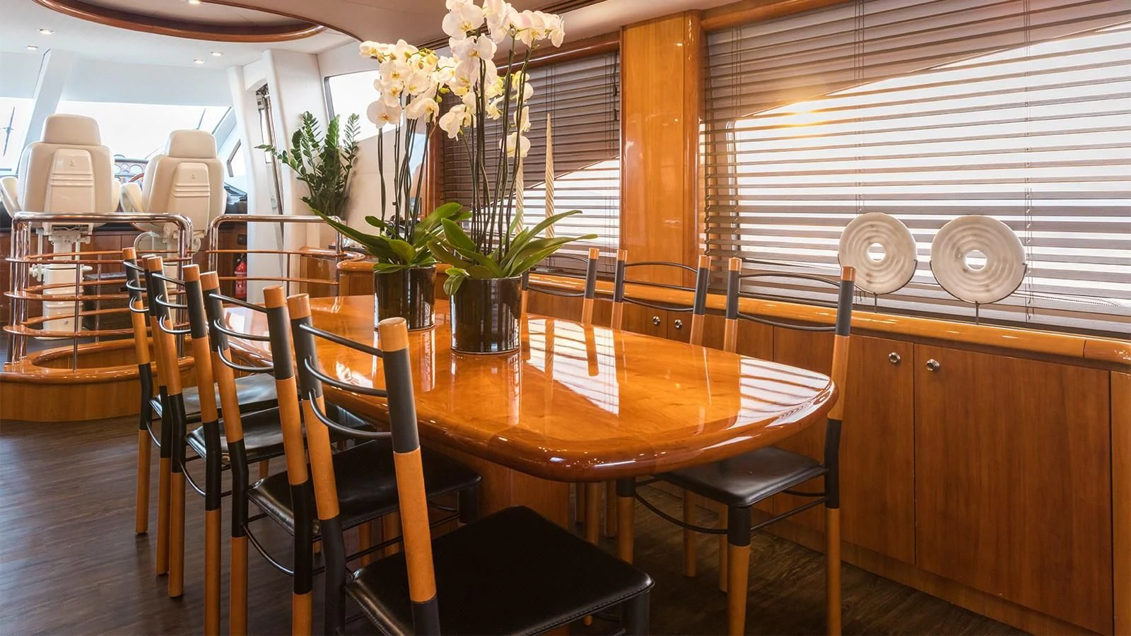 a dining table with chairs and plants aboard WINNING STREAK 2 Yacht for Sale