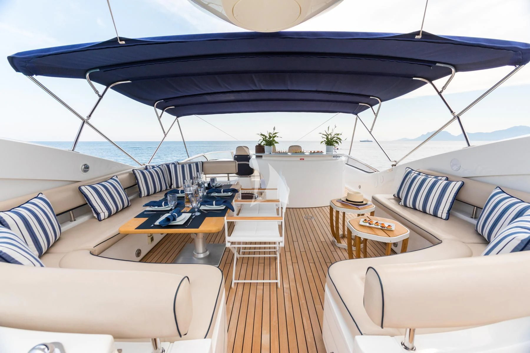 a room with a large bed and a table with chairs aboard WINNING STREAK 2 Yacht for Sale