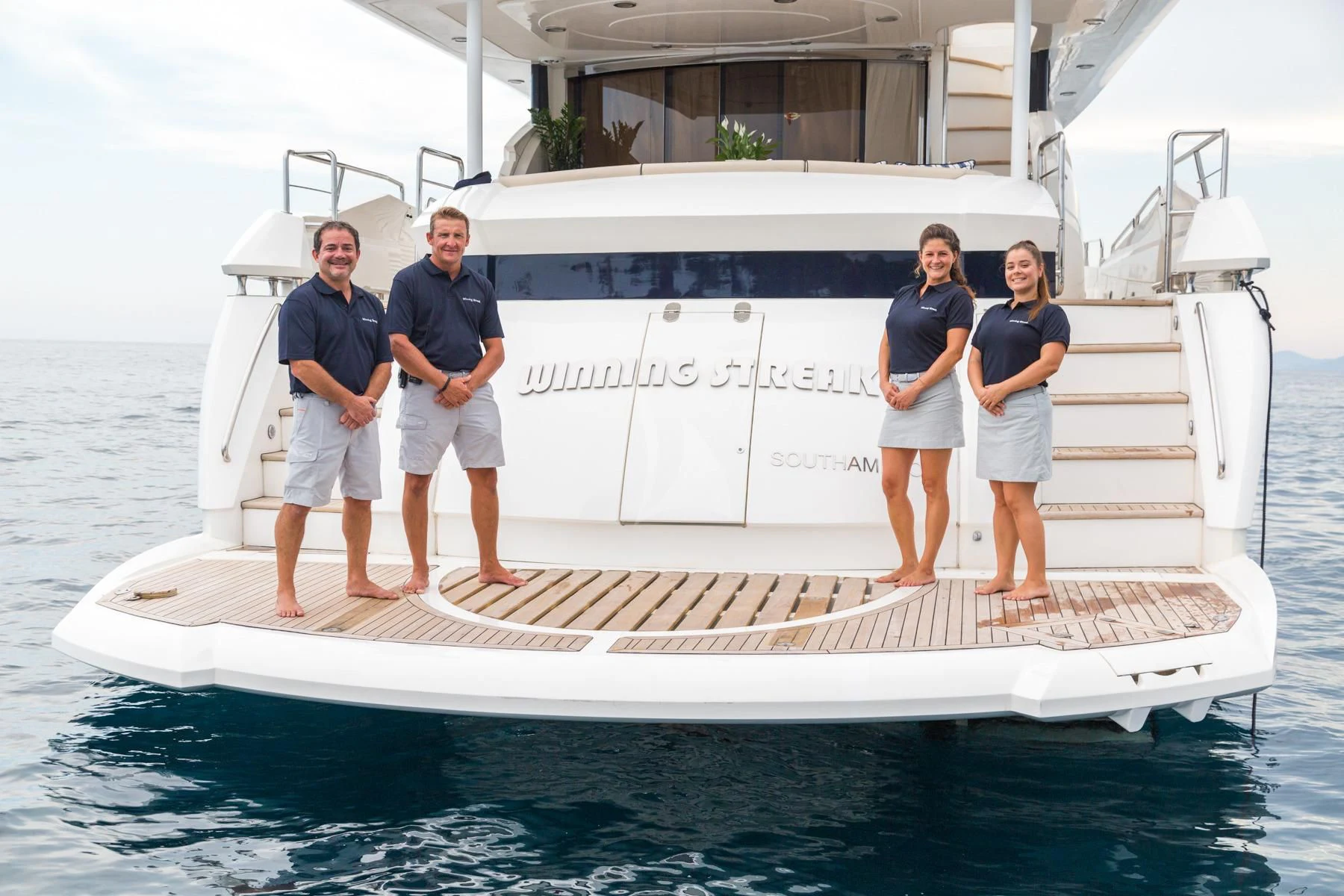 a group of people standing on a boat aboard WINNING STREAK 2 Yacht for Sale