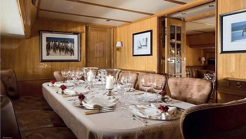 a dining room with a table set aboard SMITH Yacht for Sale
