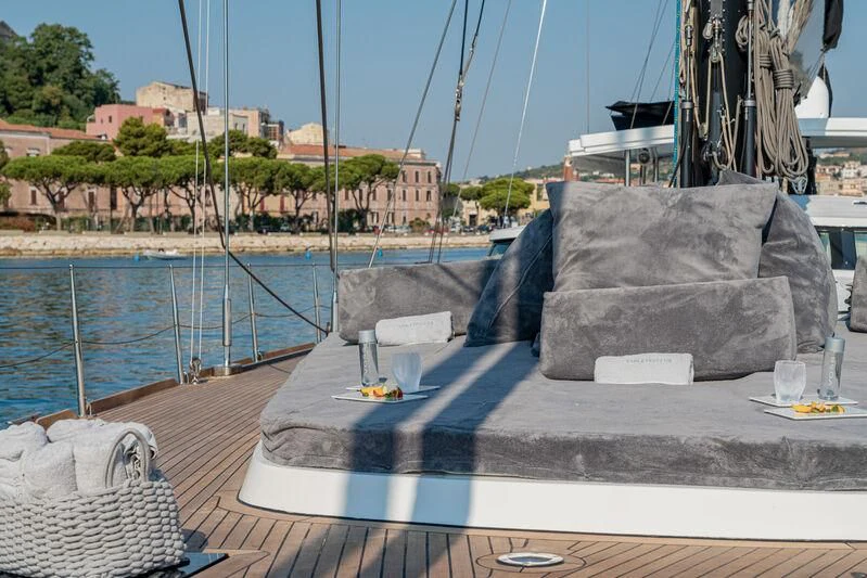 a deck with a large rock on it and a body of water in the background aboard ASHLEYROSE Yacht for Sale