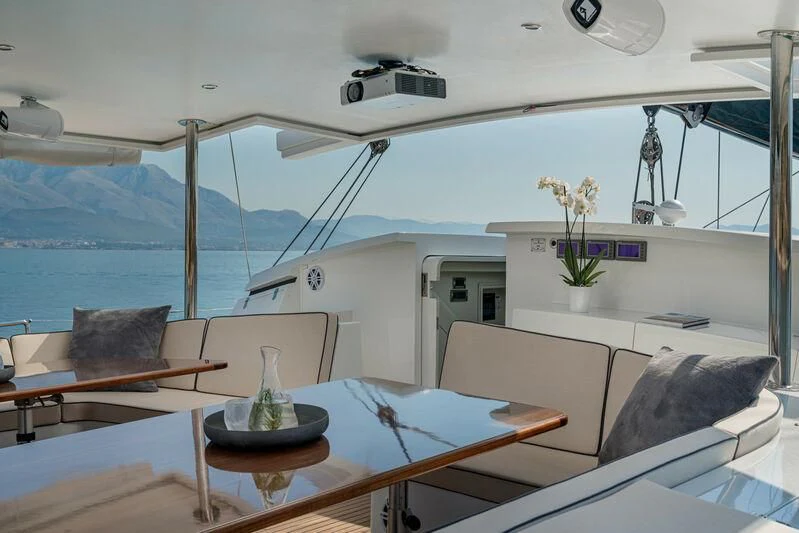 a room with a table and chairs aboard ASHLEYROSE Yacht for Sale