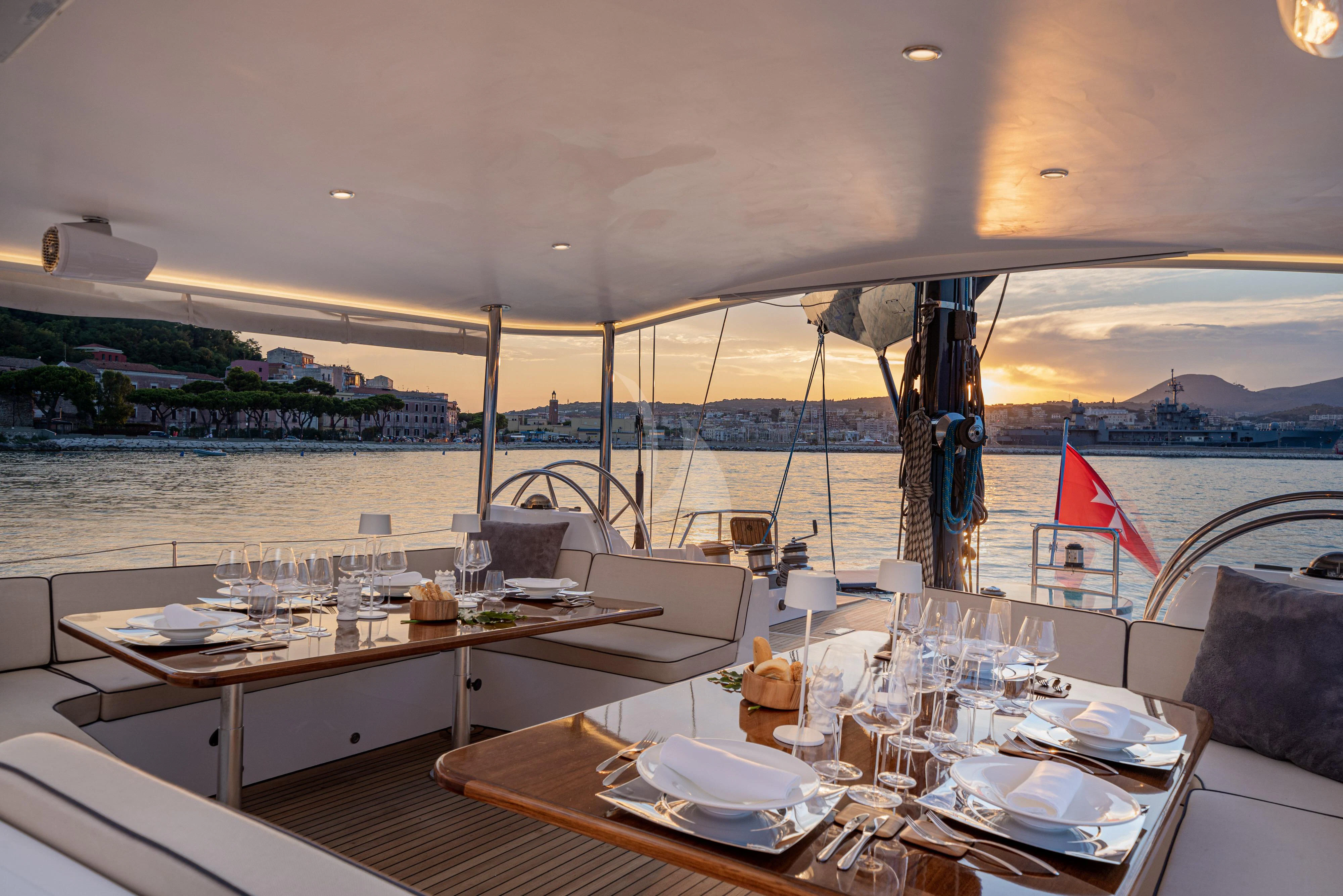 a table with plates and glasses on it aboard ASHLEYROSE Yacht for Sale