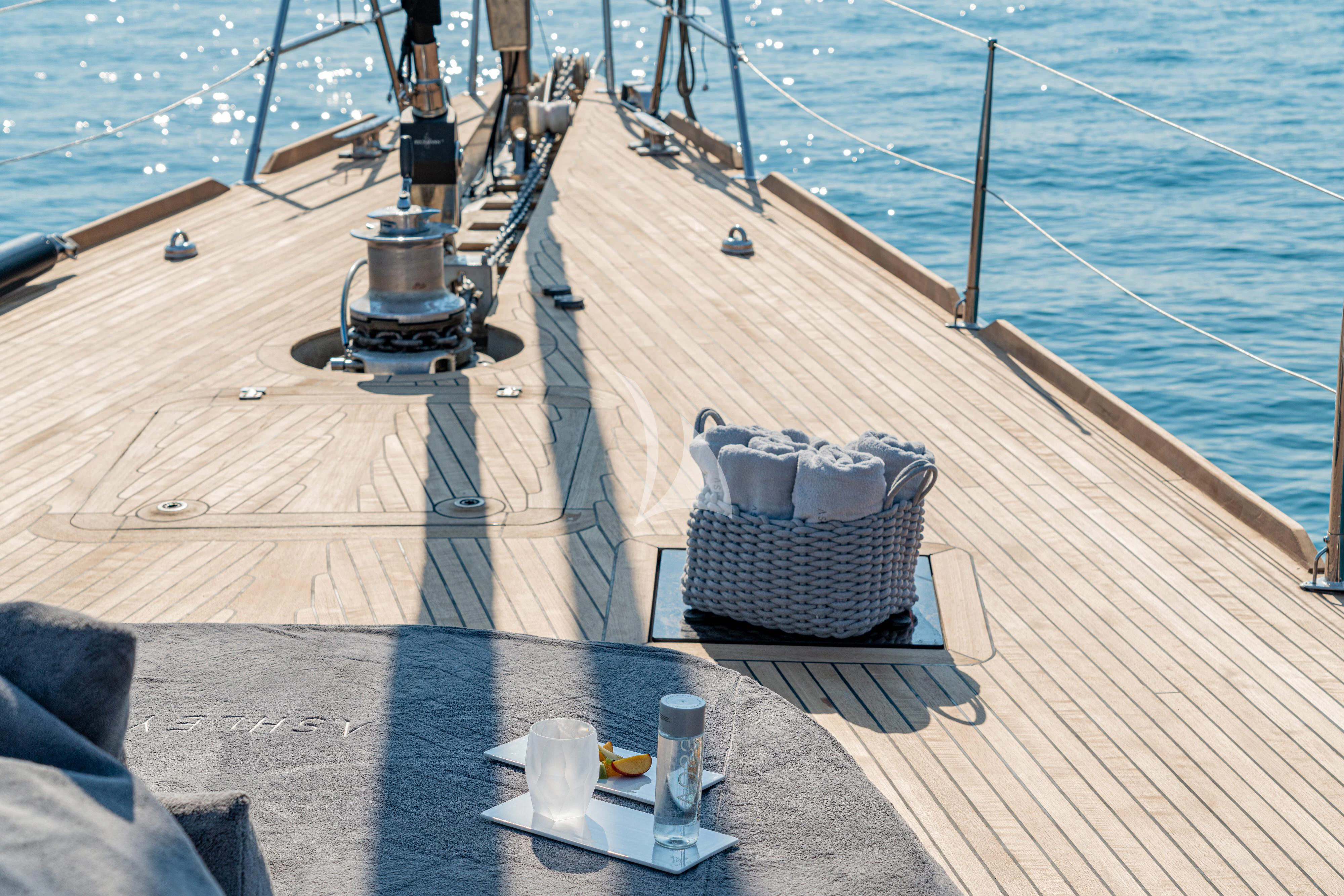 a deck with a grill and chairs on it aboard ASHLEYROSE Yacht for Sale