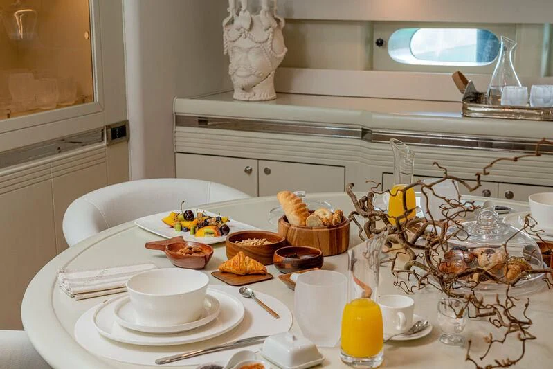 a table with food and candles aboard ASHLEYROSE Yacht for Sale