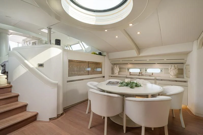 a kitchen with a table and chairs aboard ASHLEYROSE Yacht for Sale