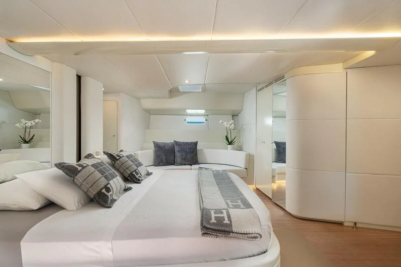 a white bed with a white bed spread and a white wall aboard ASHLEYROSE Yacht for Sale