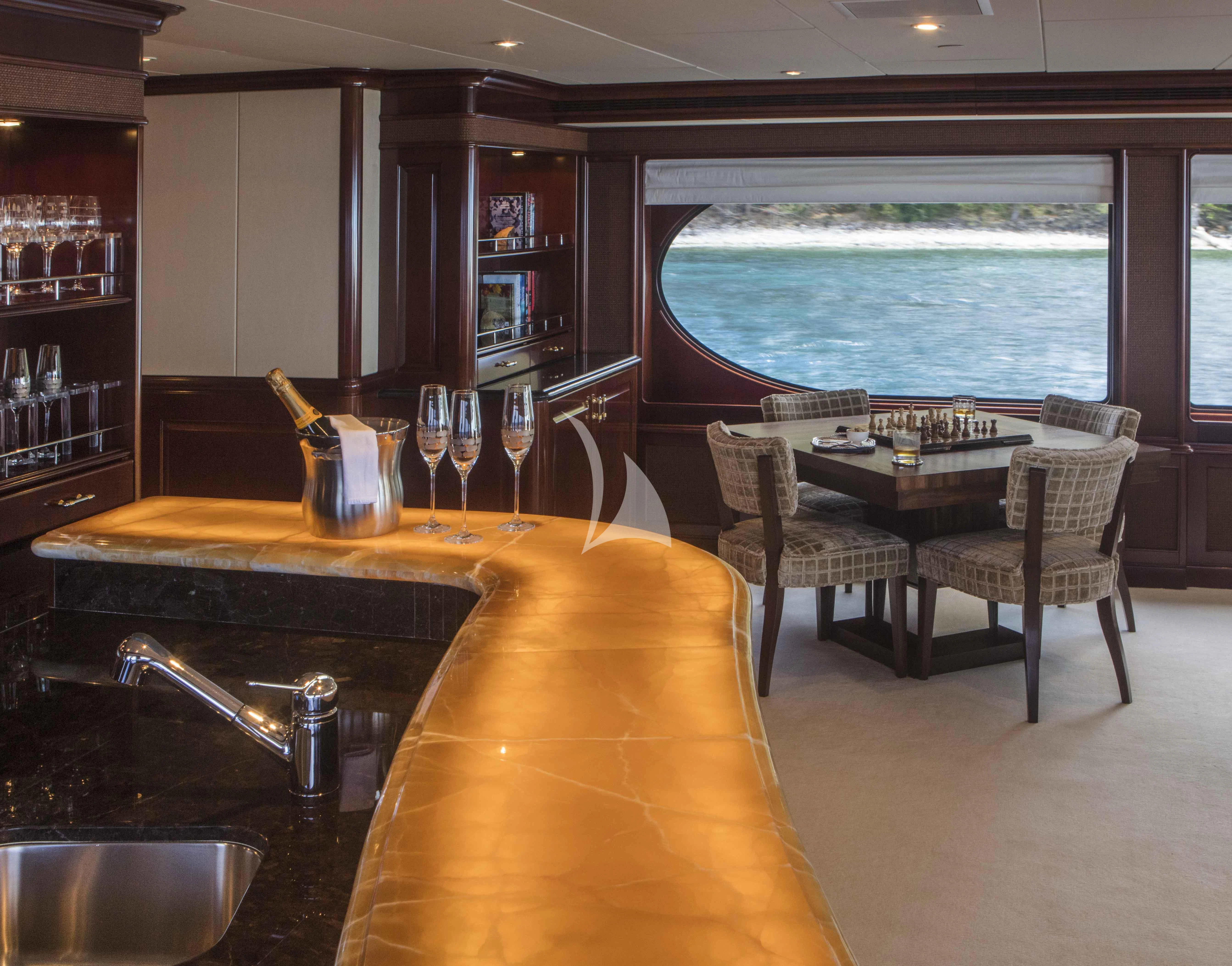 a kitchen with a table and chairs aboard MILESTONE Yacht for Sale