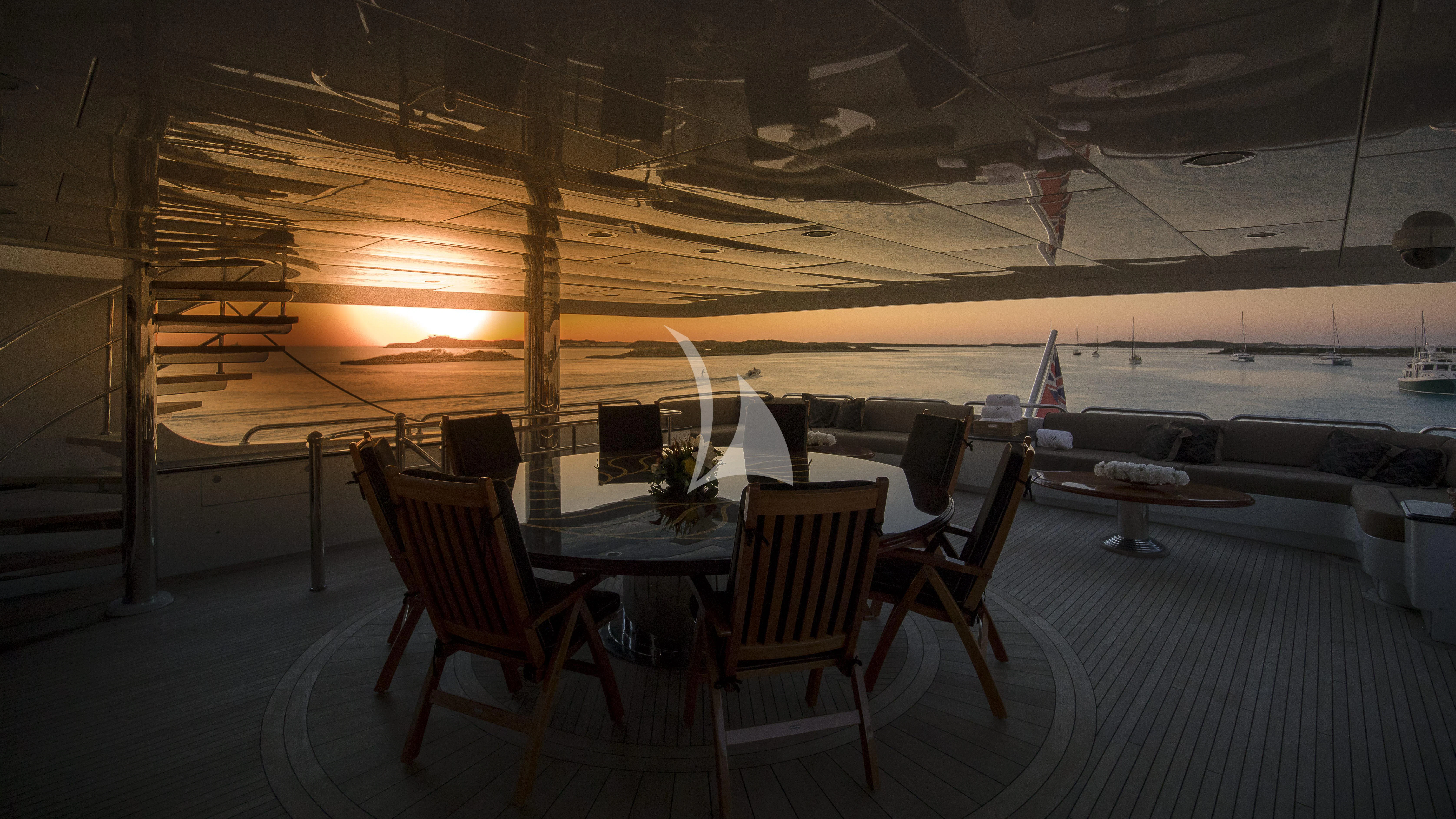 a table and chairs on a deck aboard MILESTONE Yacht for Sale