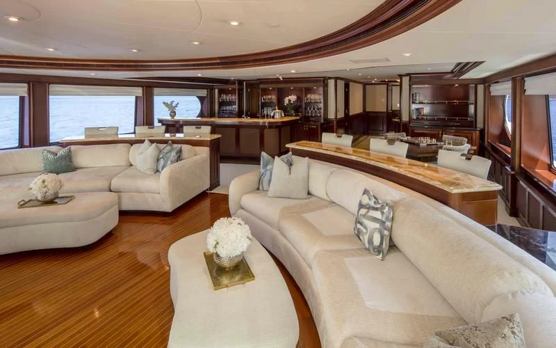 a living room with a couch and a piano aboard MILESTONE Yacht for Sale