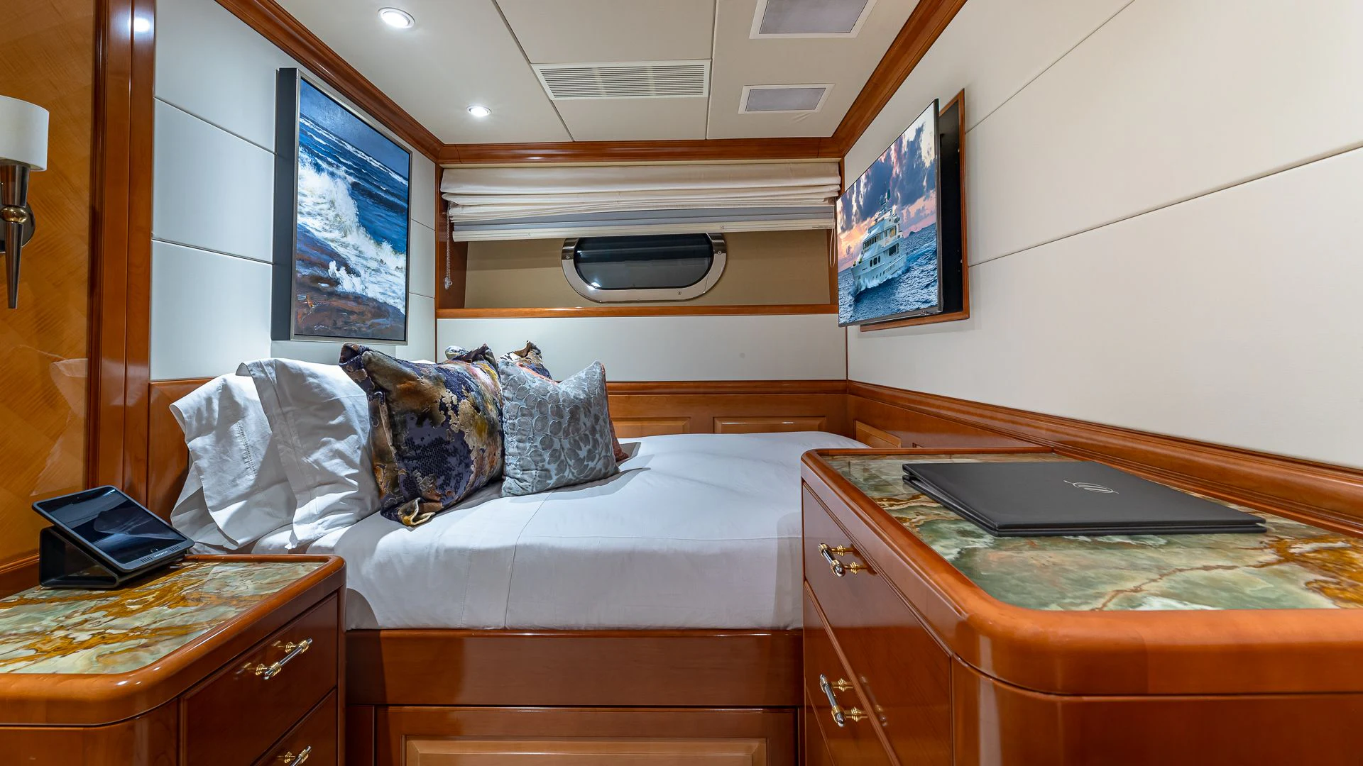 a bed with a laptop on it aboard MILESTONE Yacht for Sale