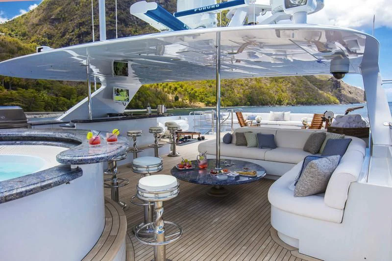 a large white lounge chair next to a large white lounge chair aboard MILESTONE Yacht for Sale