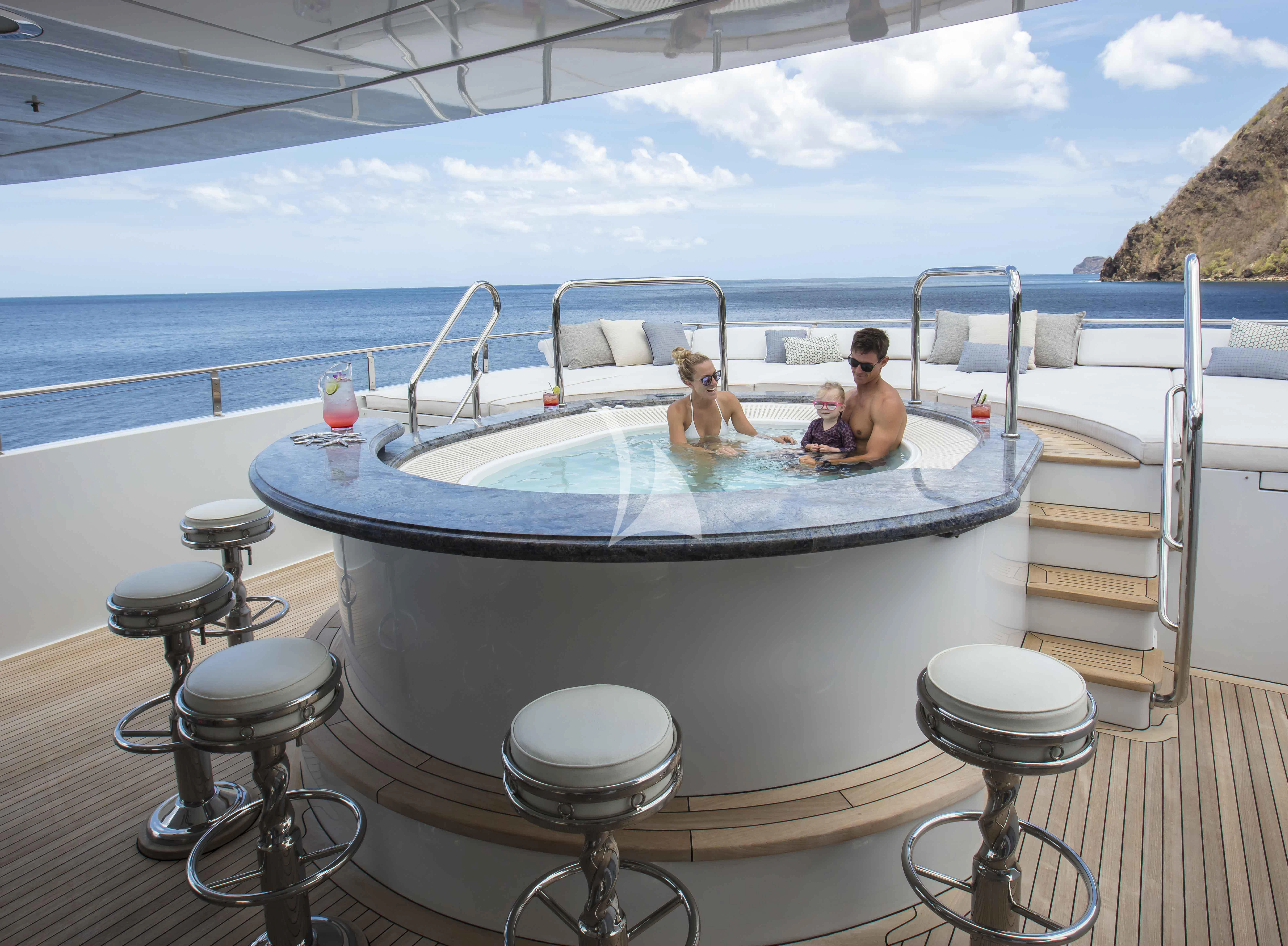 a group of people sitting in a large pool on a boat aboard MILESTONE Yacht for Sale
