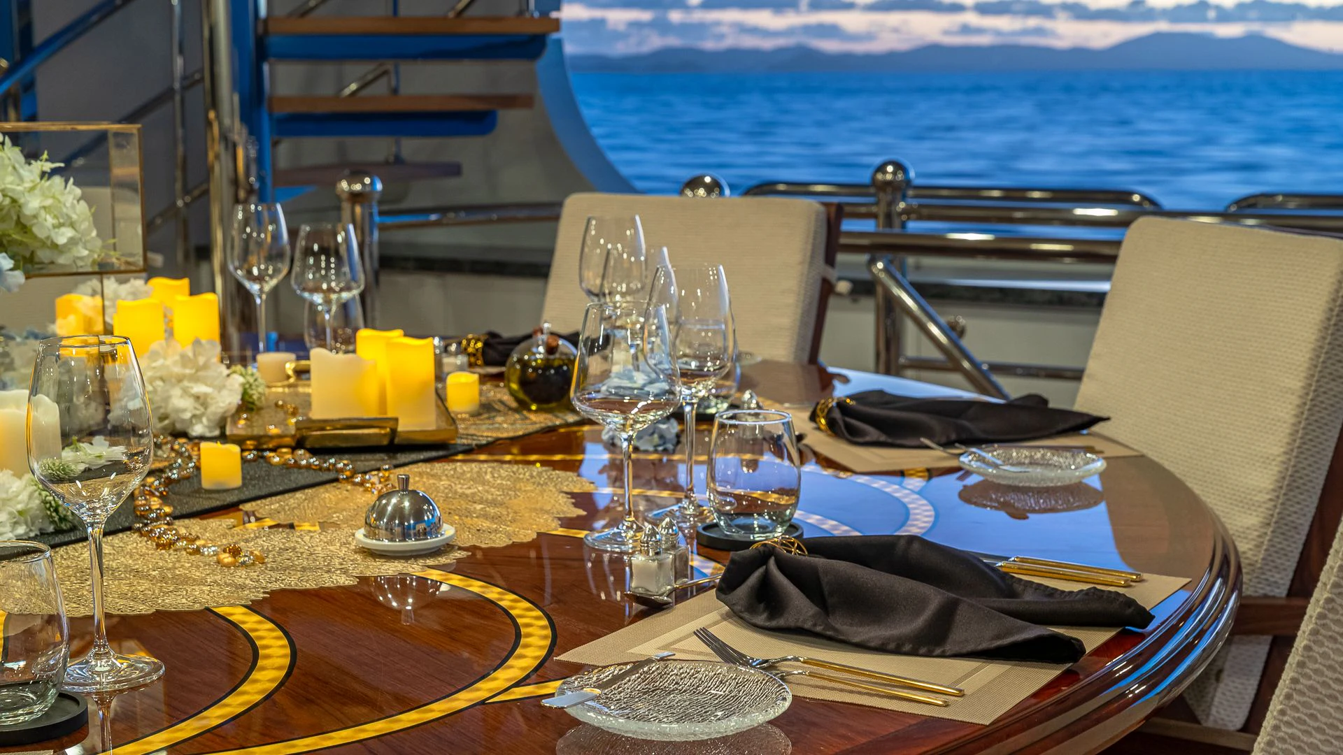 a table with wine glasses and plates on it aboard MILESTONE Yacht for Sale