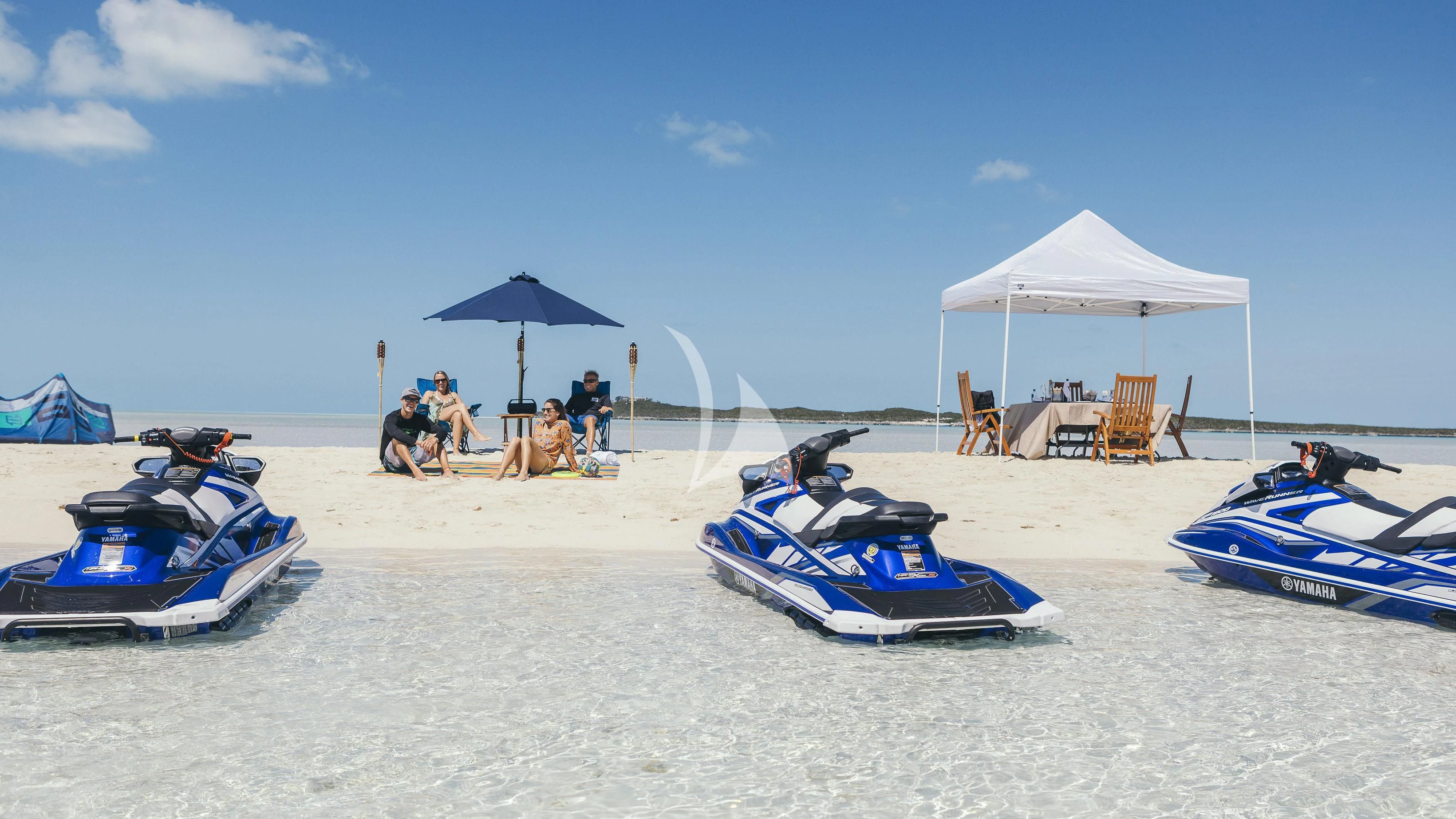 a group of people sitting on a beach with umbrellas and chairs aboard MILESTONE Yacht for Sale