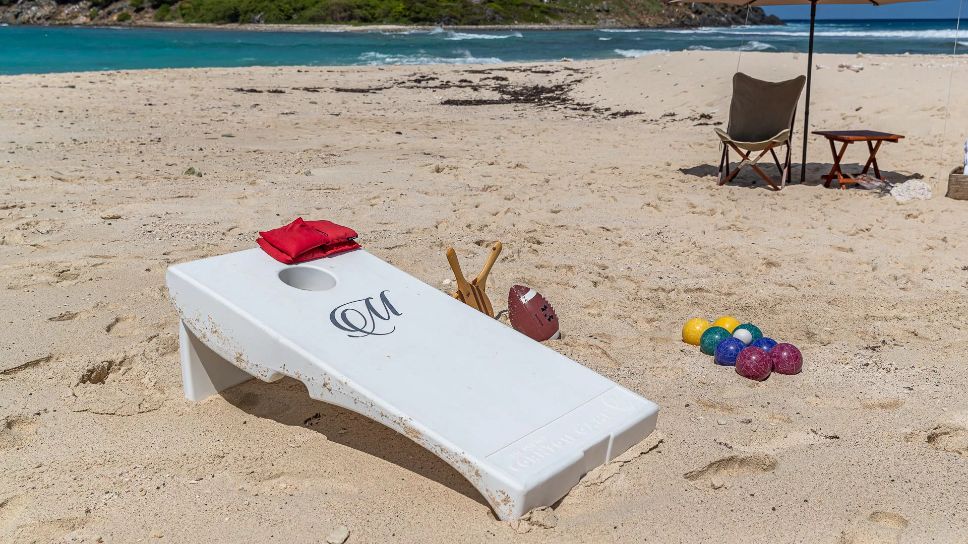 a surfboard and chair on a beach aboard MILESTONE Yacht for Sale