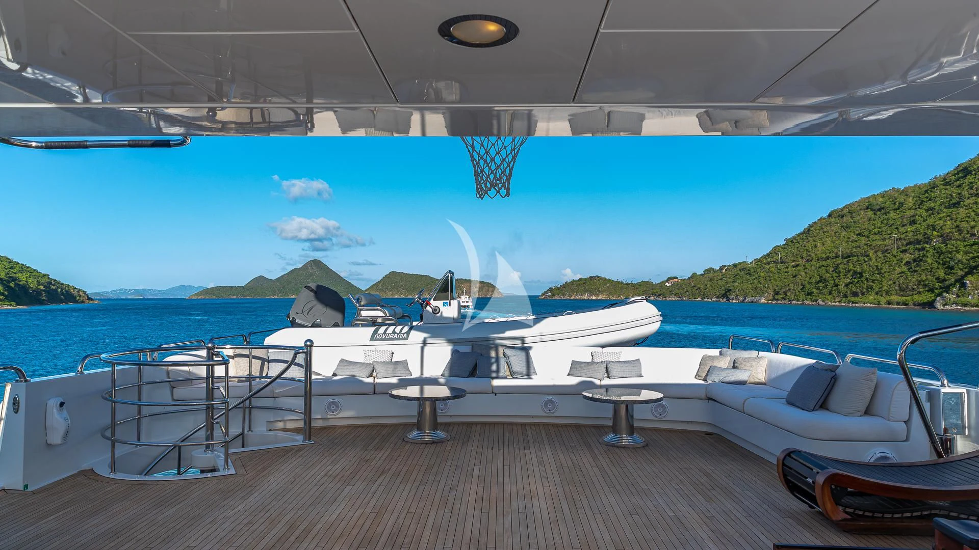 a deck with a view of the ocean and mountains aboard MILESTONE Yacht for Sale