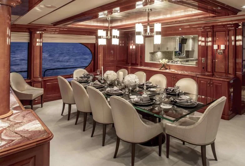 a dining room with tables and chairs aboard MILESTONE Yacht for Sale