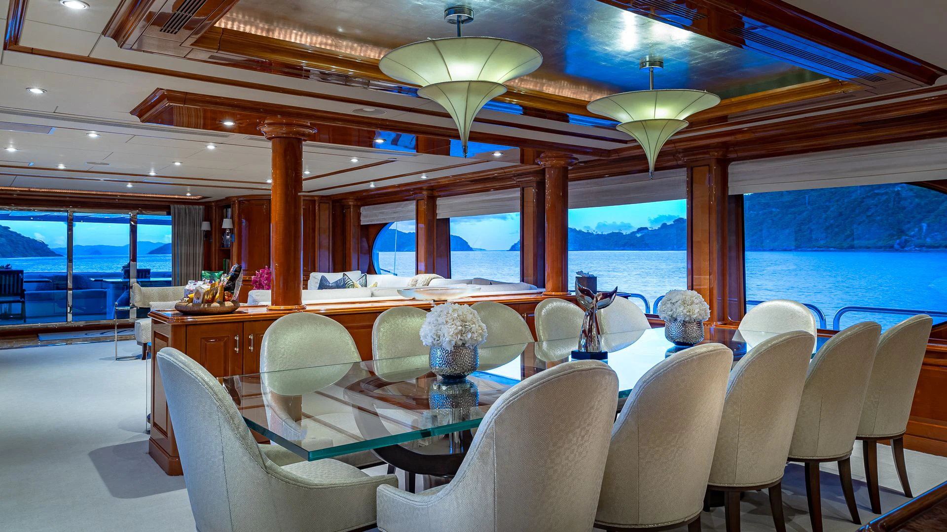 a room with a table chairs and a view of the ocean aboard MILESTONE Yacht for Sale