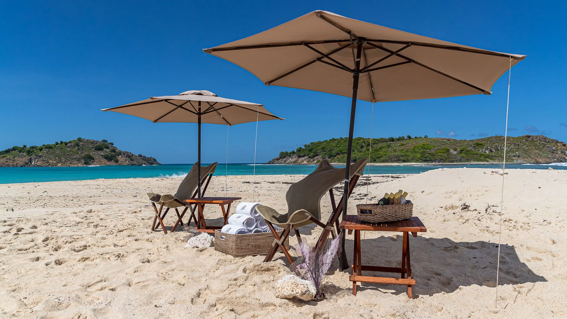 a couple of chairs and an umbrella on a beach aboard MILESTONE Yacht for Sale