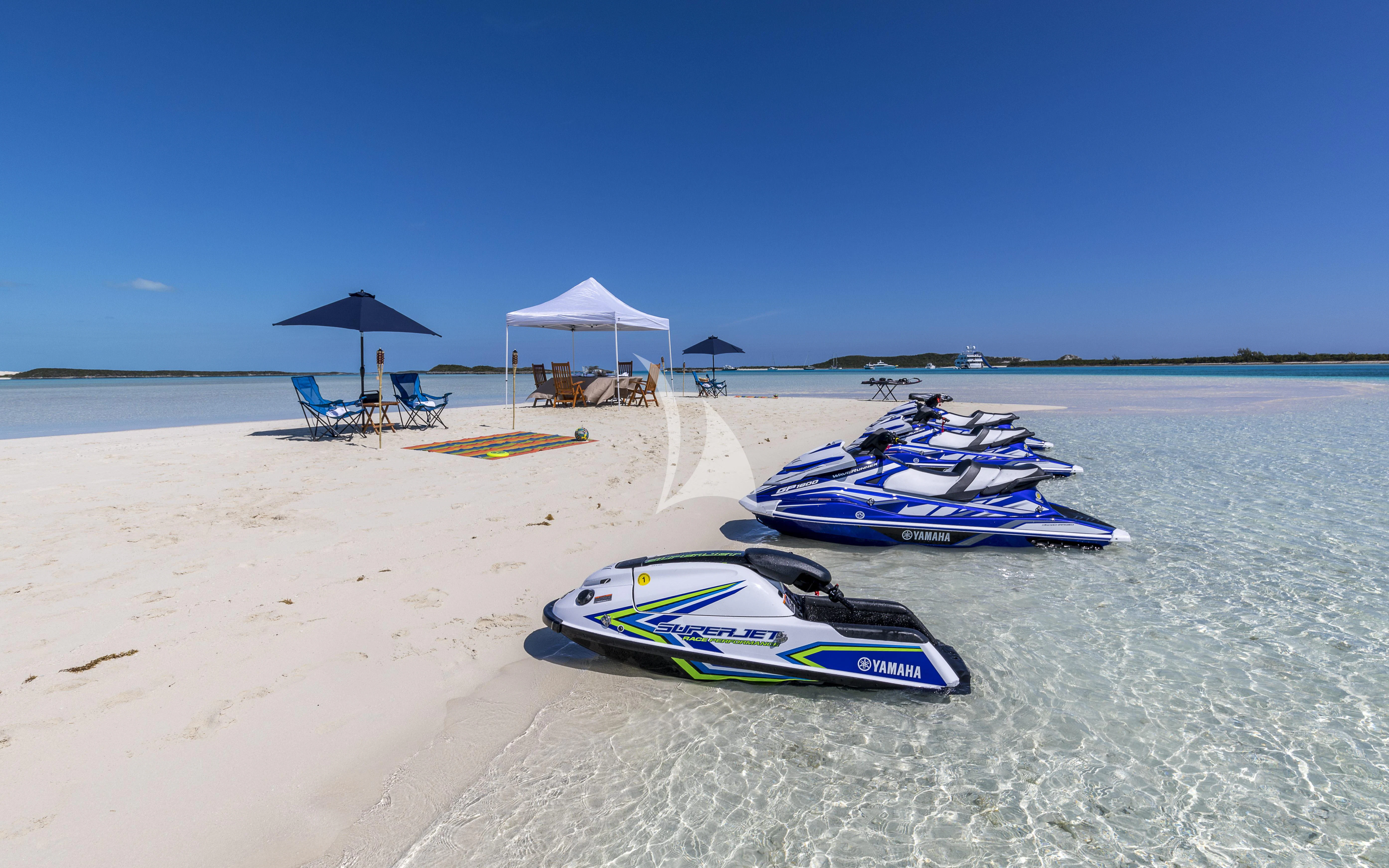 a couple of boats sit on a beach aboard MILESTONE Yacht for Sale