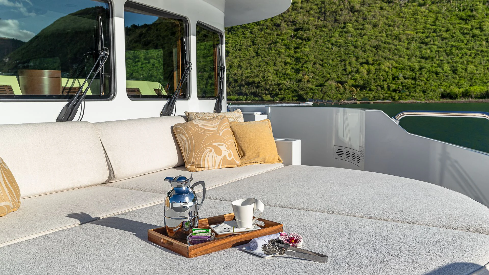a white couch with a coffee table and a coffee table on a boat aboard MILESTONE Yacht for Sale