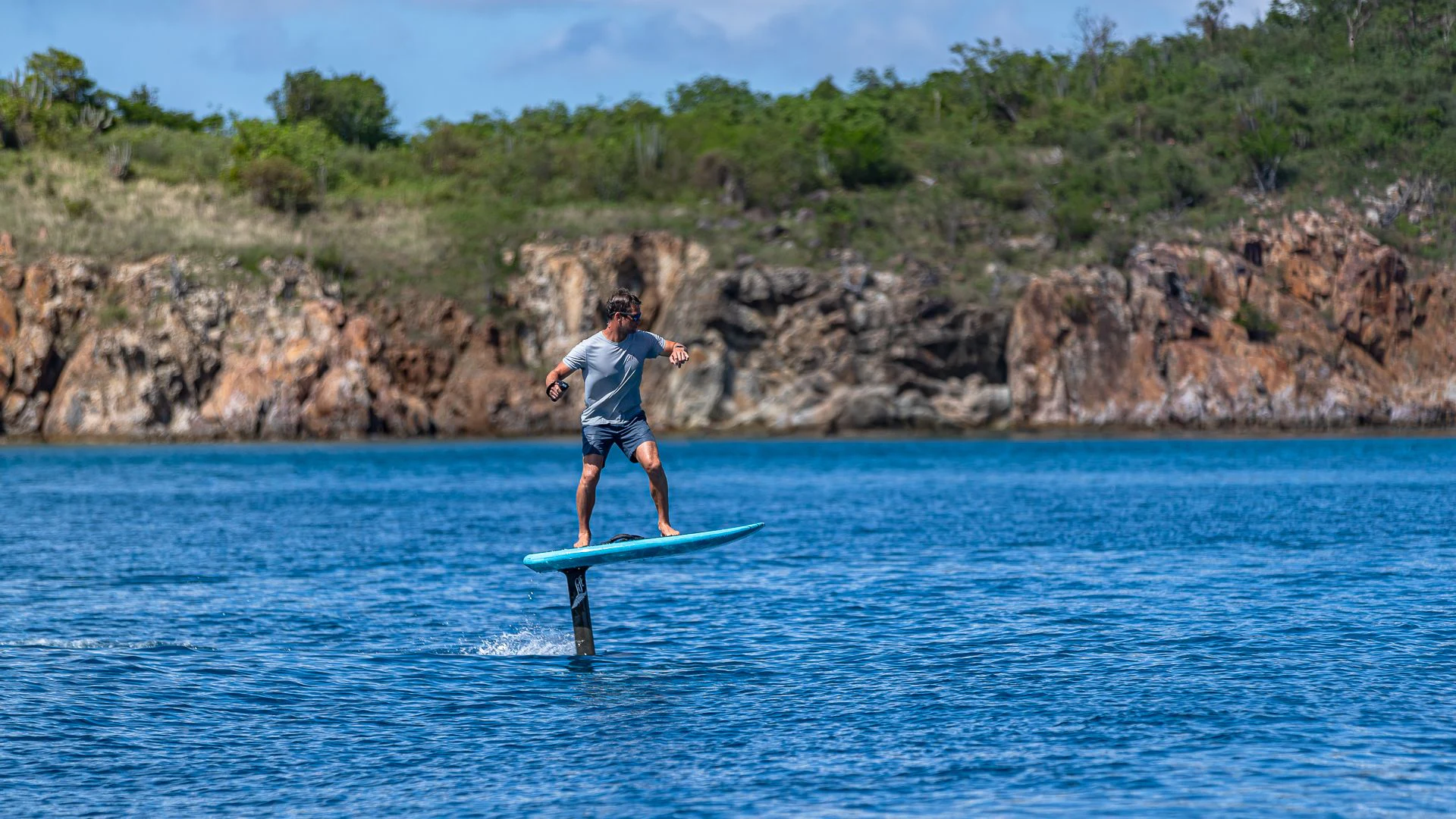 a man riding a surfboard aboard MILESTONE Yacht for Sale