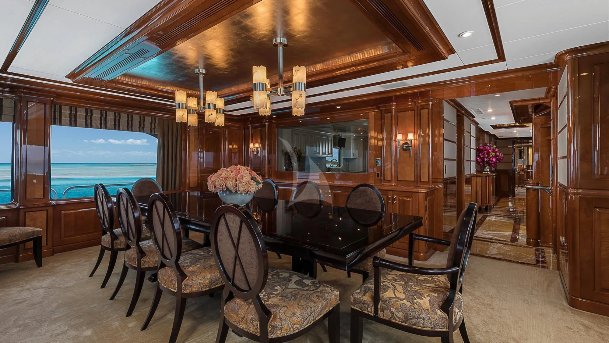 a room with a chandelier and chairs aboard MILESTONE Yacht for Sale