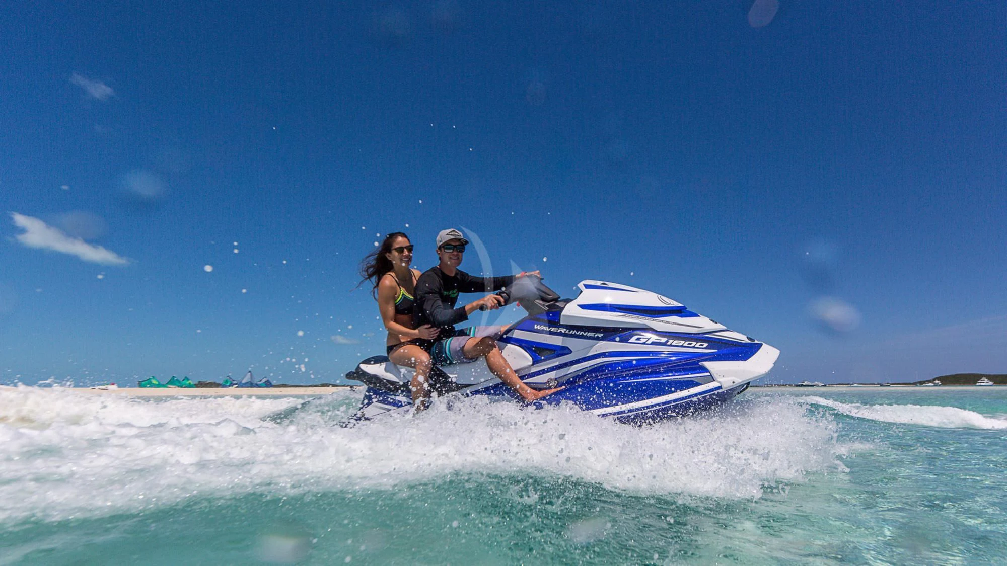 a man and woman riding a jet ski in the ocean aboard MILESTONE Yacht for Sale