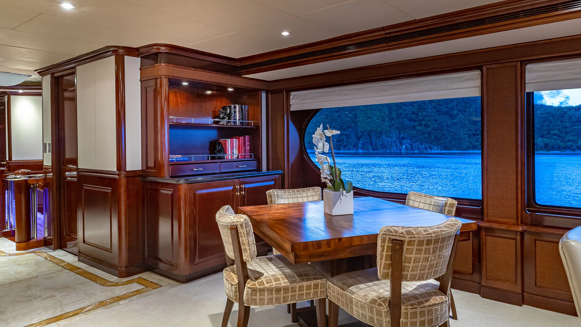 a room with a table chairs and a tv aboard MILESTONE Yacht for Sale