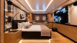a room with a bed and a mirror aboard ALASKA Yacht for Sale