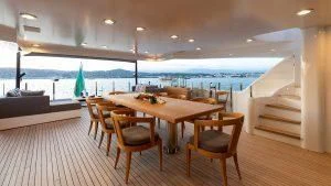a table and chairs on a deck aboard ALASKA Yacht for Sale