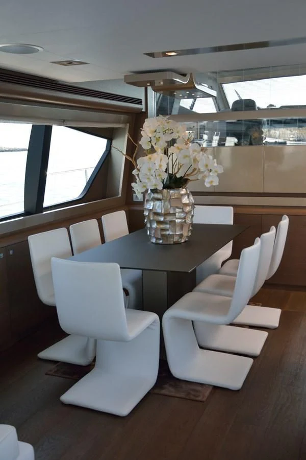 a white table with white chairs aboard HEAL Yacht for Sale