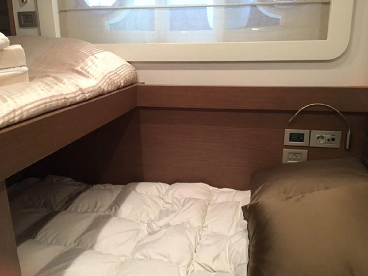 a bed with a couple of beds aboard HEAL Yacht for Sale
