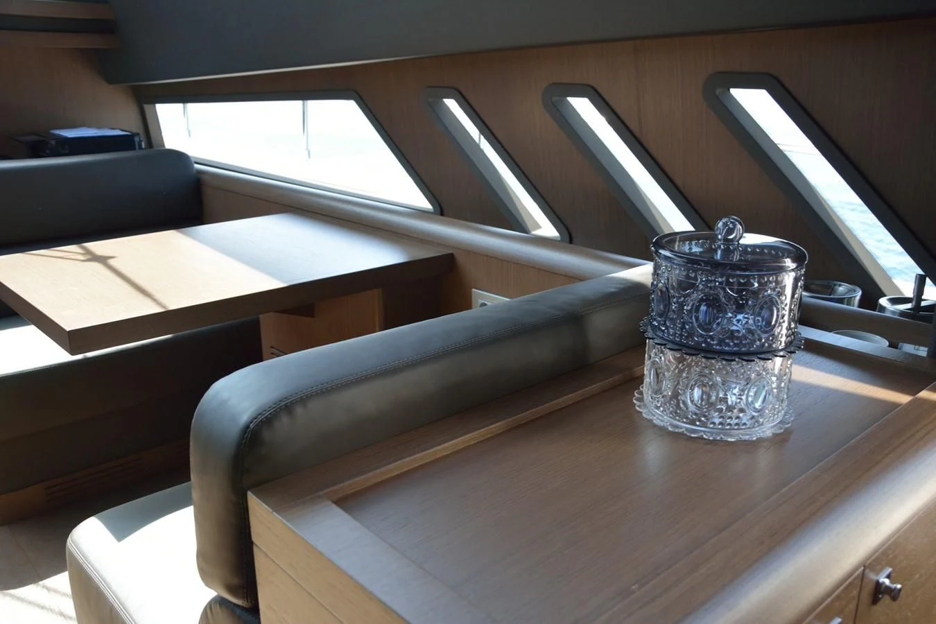a cup on a desk aboard HEAL Yacht for Sale