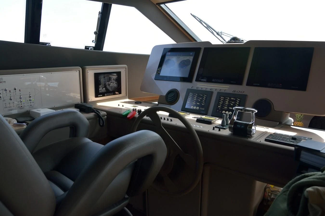 a desk with computers and monitors aboard HEAL Yacht for Sale