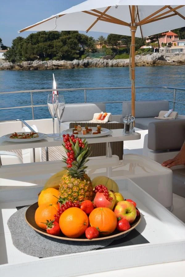 a table with fruit on it aboard HEAL Yacht for Sale